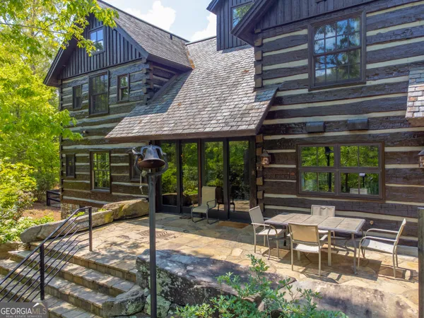a backyard of a house with lots of green space and lake view