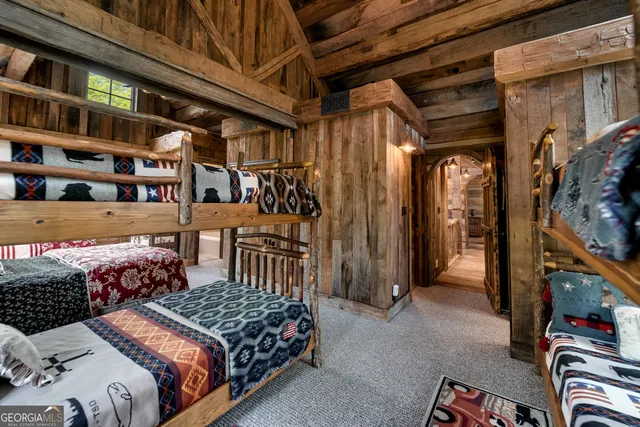 a view of a patio with table and chairs potted plants and floor to ceiling window