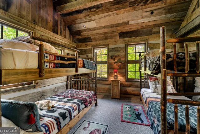 a view of a patio with table and chairs potted plants and large tree