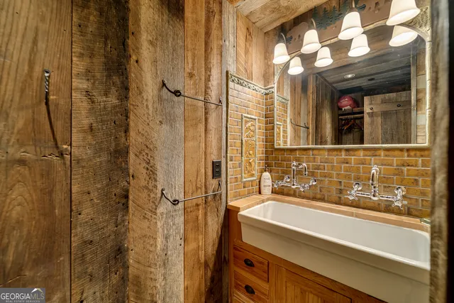 a view of a lake with a bench and trees around