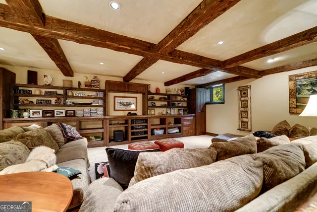 an aerial view of a house with a yard and lake view