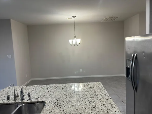 a kitchen with a sink and chandelier