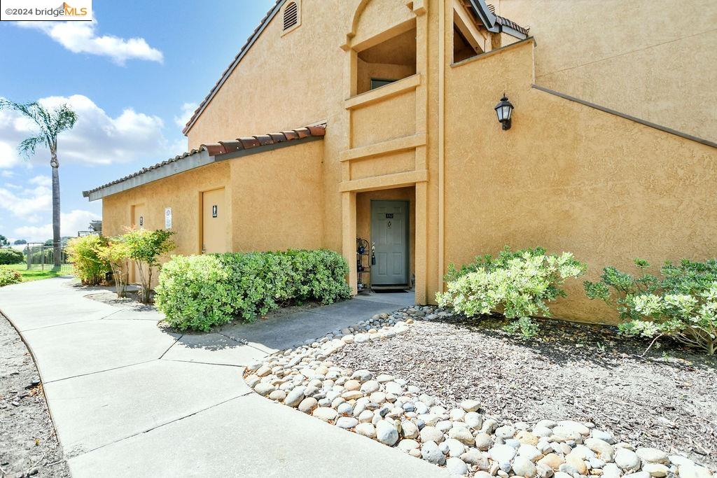 a front view of a house with a yard and flowers