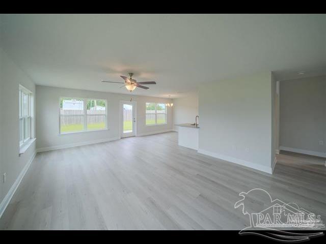 8049 Westpointe Lane, Unit 11B Pensacola, FL 32506 - Photo 2 of 5 a view of an empty room with window and wooden floor