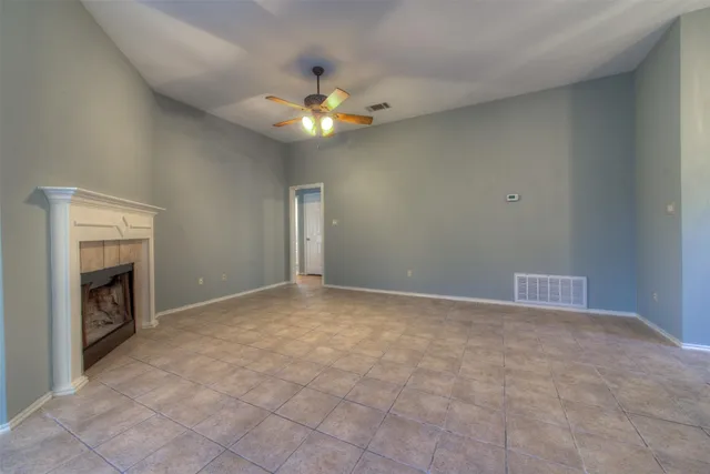 a view of an empty room with a fireplace