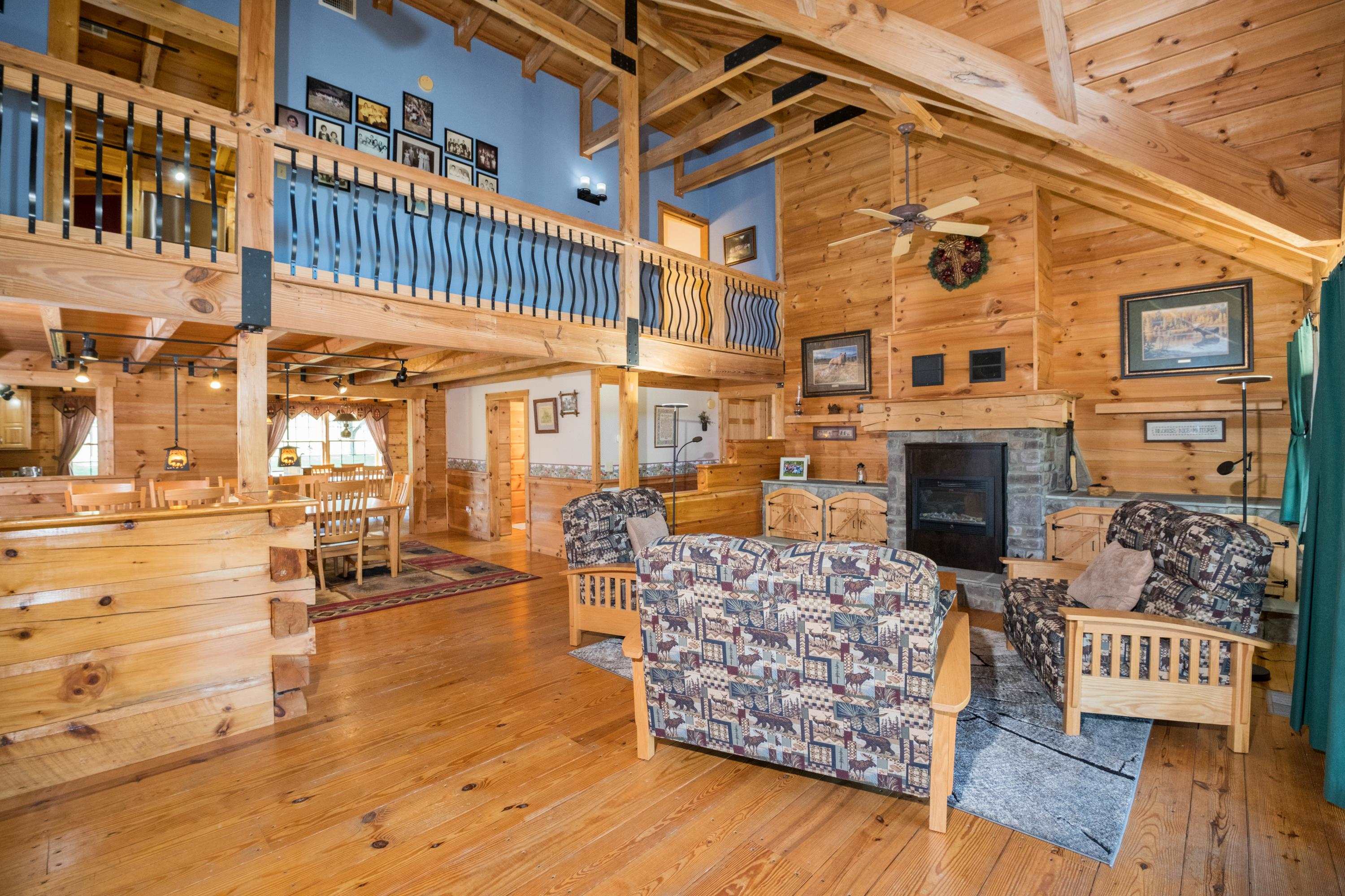 14238 Plains Mill Road Timberville, VA 22853 - Photo 17 of 68 a view of a patio with couches table and chairs and wooden floor