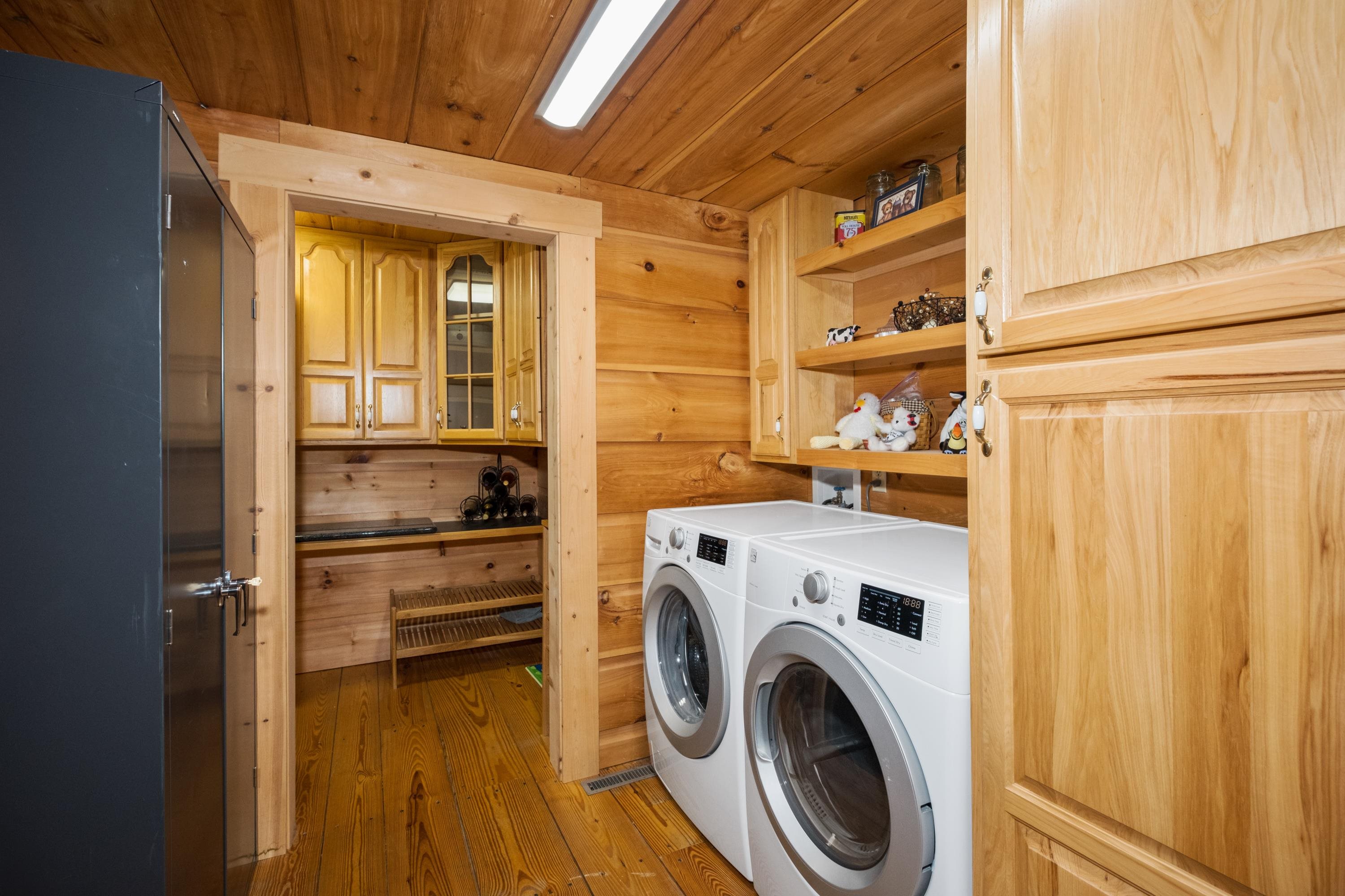 14238 Plains Mill Road Timberville, VA 22853 - Photo 20 of 68 a view of washer and dryer with kitchen in the background