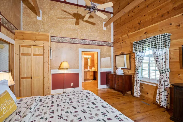a bedroom with furniture and a wooden floor
