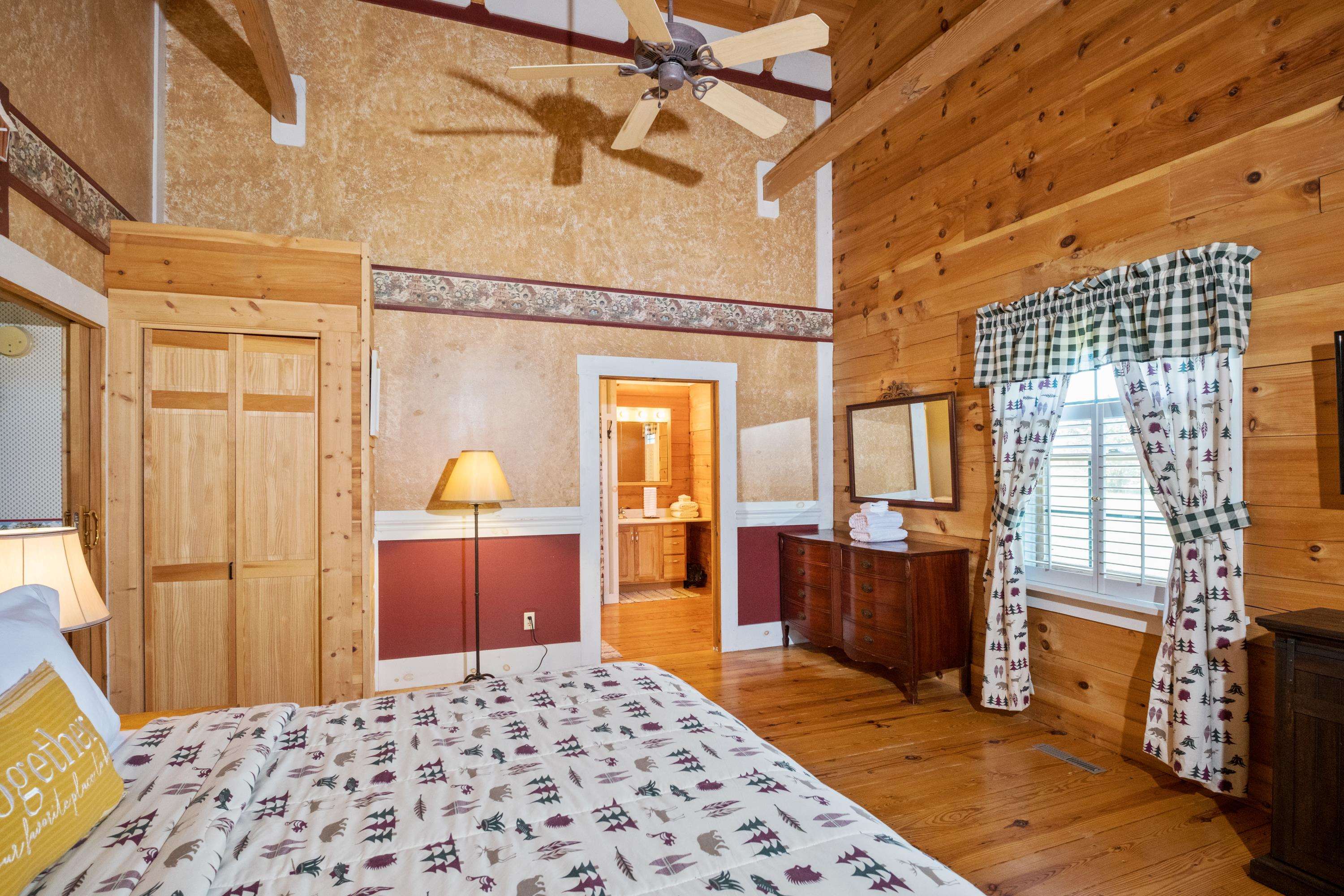 14238 Plains Mill Road Timberville, VA 22853 - Photo 26 of 68 a bedroom with a bed and wooden cabinets