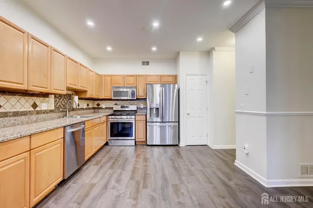 a view of a room with wooden floor