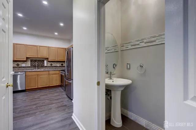 a bathroom with a sink a toilet and mirror