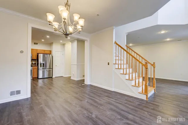 an empty room with wooden floor and fireplace
