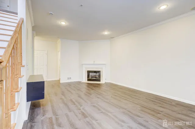 a view of a kitchen with wooden floor and stainless steel appliances