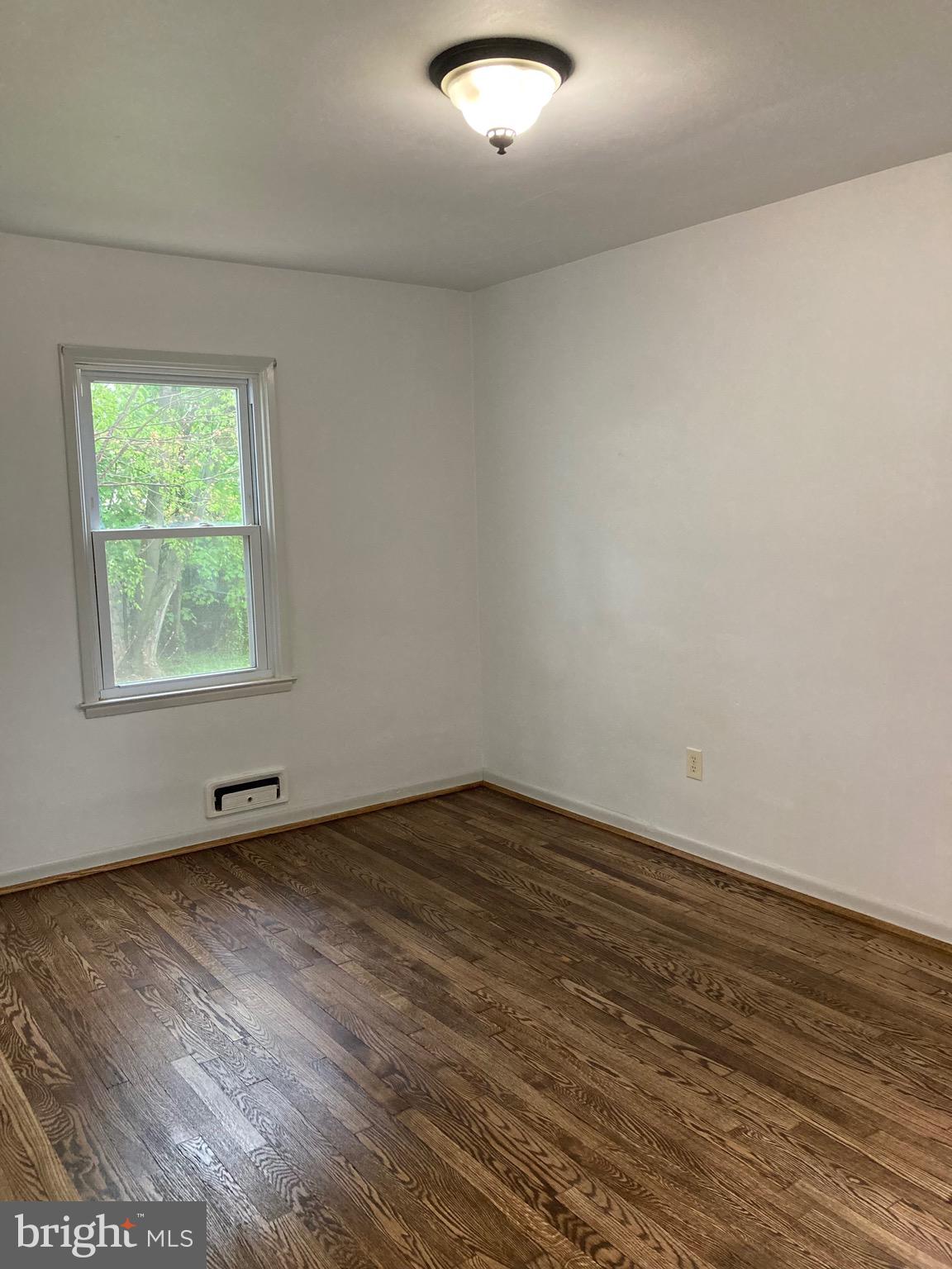 11320 Greenberry Road Hagerstown, MD 21740 - Photo 15 of 16 an empty room with wooden floor and windows