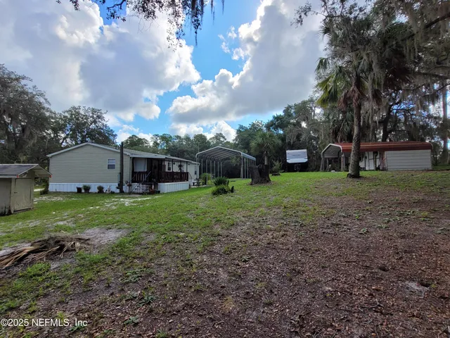 a kitchen with granite countertop a refrigerator and a sink
