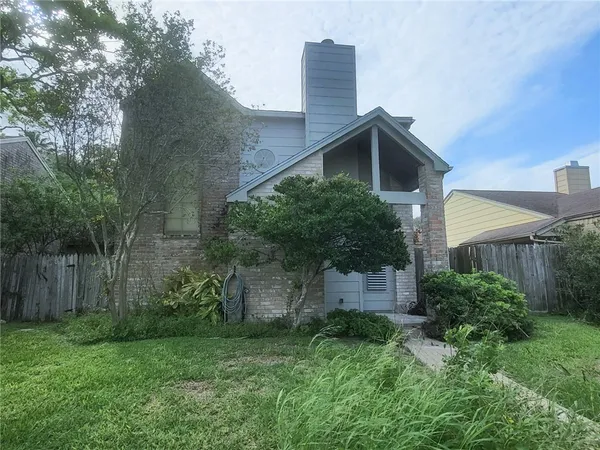 a front view of house with a yard and a fence