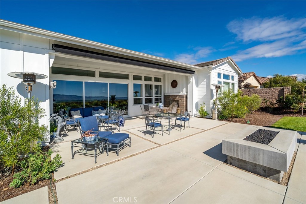 1650 Eucalyptus Road Nipomo, CA 93444 - Photo 38 of 60 a view of a patio with couches and table and chairs with wooden fence and plants