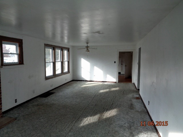 292 West Cermak Road Braidwood, IL 60408 - Photo 3 of 25 an empty room with windows and stairs