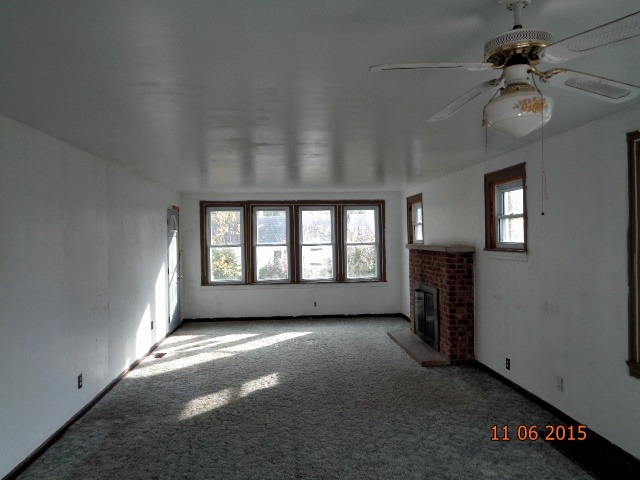 292 West Cermak Road Braidwood, IL 60408 - Photo 4 of 25 an empty room with windows and fan