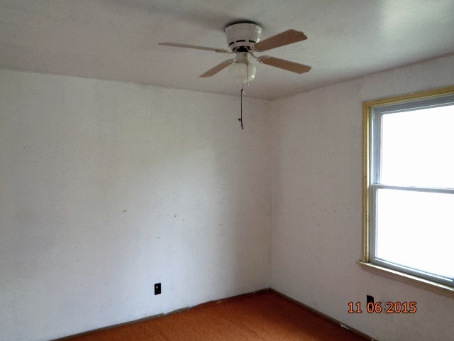 292 West Cermak Road Braidwood, IL 60408 - Photo 7 of 25 an empty room with a window and a fan