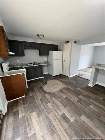 a kitchen with stainless steel appliances granite countertop a sink and a stove