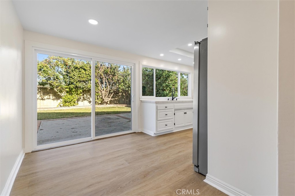 4533 Ironwood Avenue Seal Beach, CA 90740 - Photo 11 of 24 an empty room with wooden floor and windows
