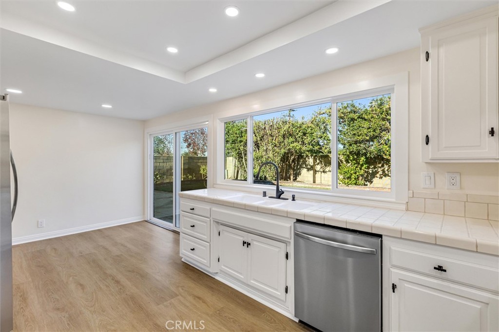 4533 Ironwood Avenue Seal Beach, CA 90740 - Photo 14 of 24 a kitchen with a sink and large window
