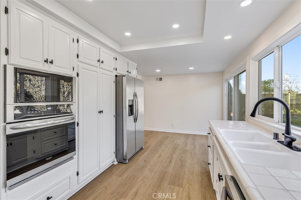 4533 Ironwood Avenue Seal Beach, CA 90740 - Photo 15 of 24 a kitchen with stainless steel appliances a stove microwave and sink