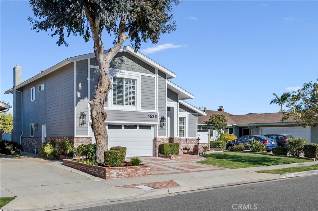 4533 Ironwood Avenue Seal Beach, CA 90740 - Photo 2 of 24 a front view of a house with a garden