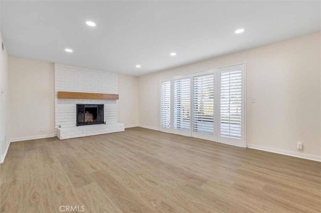 4533 Ironwood Avenue Seal Beach, CA 90740 - Photo 9 of 24 a view of an empty room with a fireplace and a window