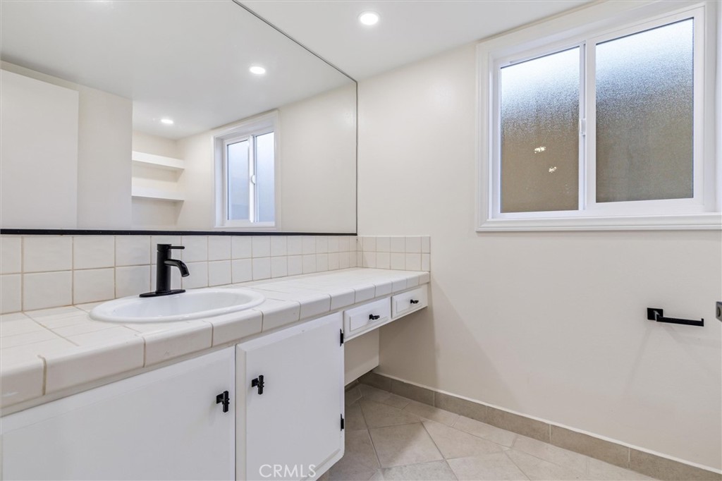 4533 Ironwood Avenue Seal Beach, CA 90740 - Photo 10 of 24 a bathroom with a sink and a mirror