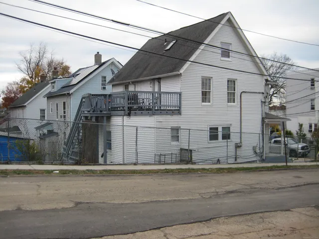 a view of a white house with large windows