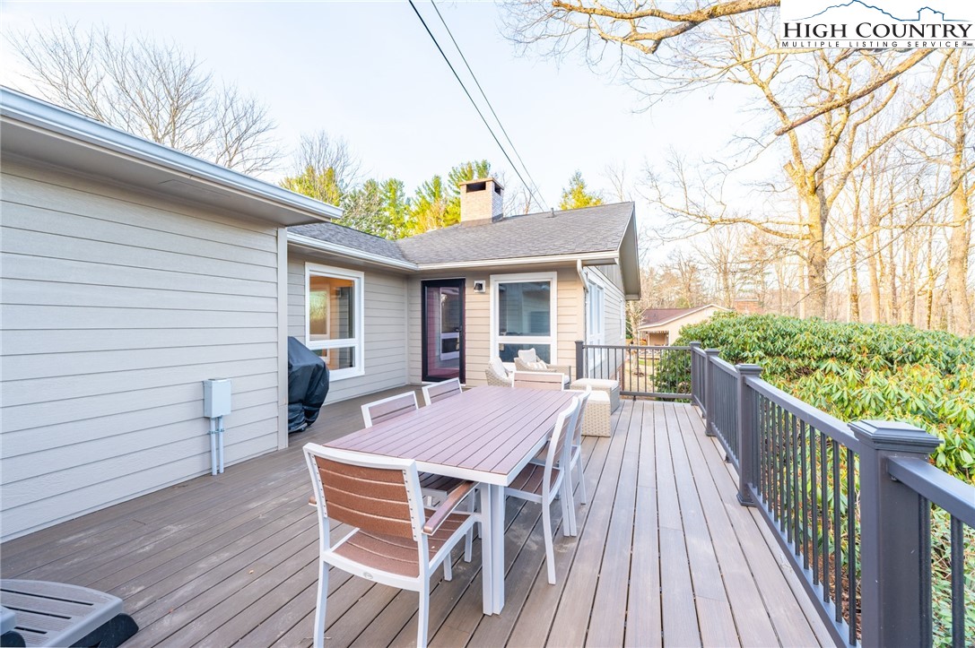 197 Sierra Vista Boone, NC 28607 - Photo 34 of 41 a view of a patio with table and chairs with wooden floor and fence