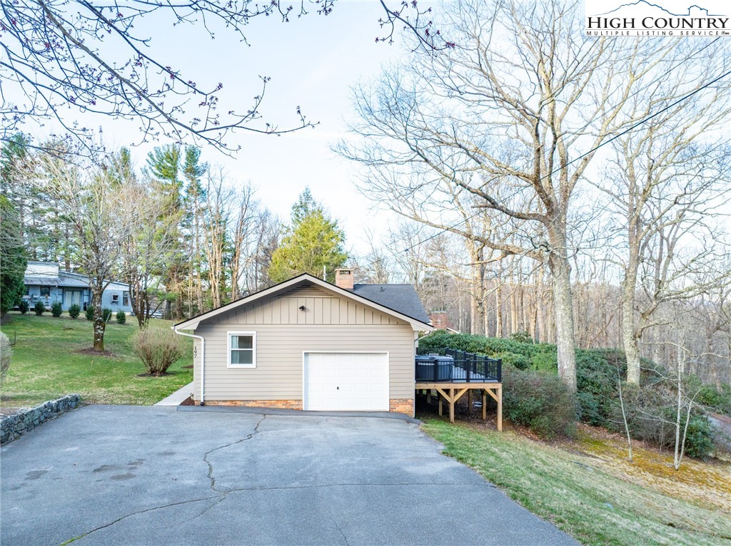 197 Sierra Vista Boone, NC 28607 - Photo 37 of 41 a view of backyard with a table and chairs under an umbrella