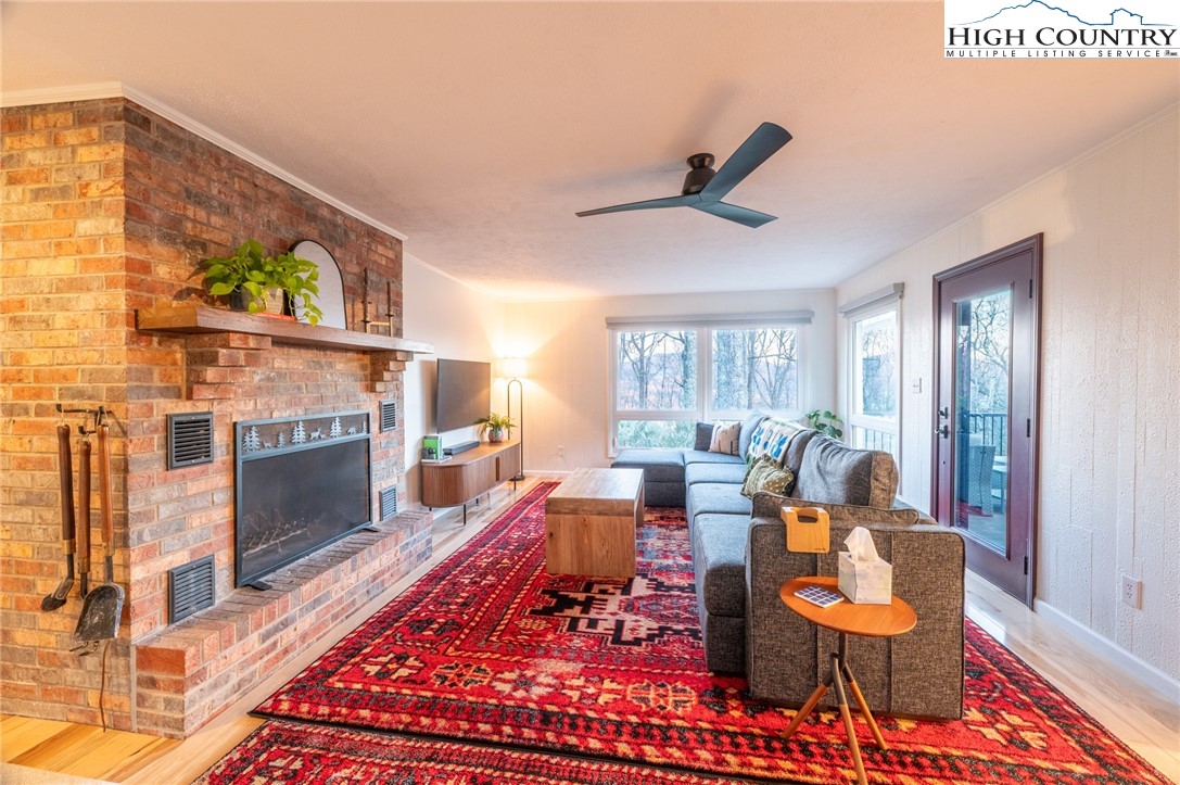 197 Sierra Vista Boone, NC 28607 - Photo 7 of 41 a living room with furniture a fireplace and a window