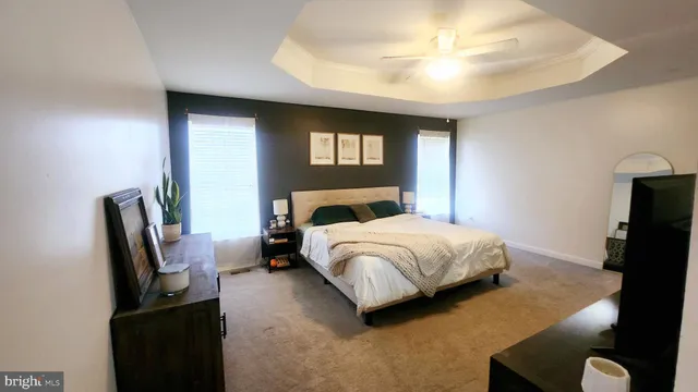 a bedroom with a bed and dresser with mirror