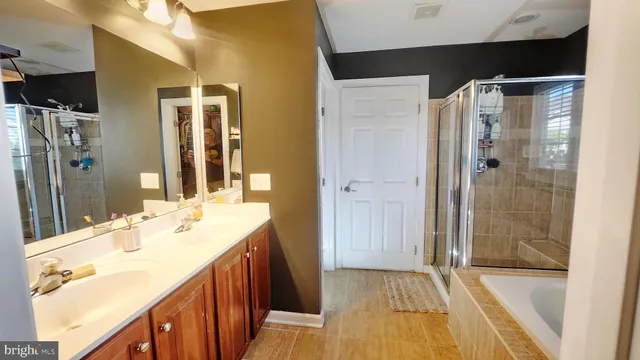 a bathroom with a double vanity sink toilet and shower