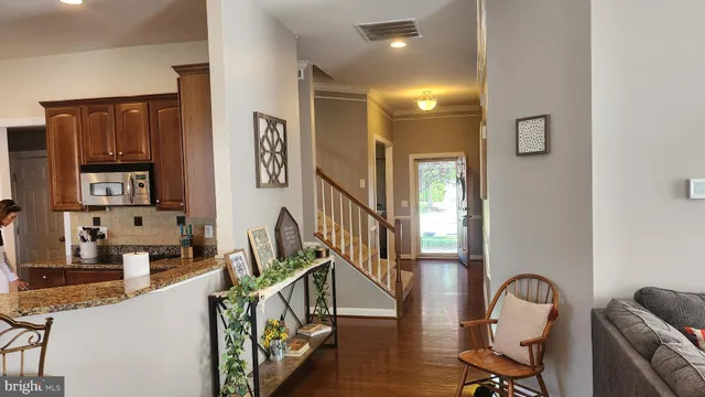a view of a livingroom with furniture and staircase