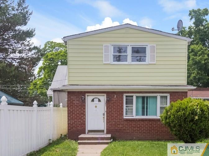 385 Florida Grove Road Perth Amboy, NJ 08861 - Photo 1 of 13 a front view of a house with a yard