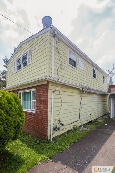 385 Florida Grove Road Perth Amboy, NJ 08861 - Photo 2 of 13 a front view of a house with a yard