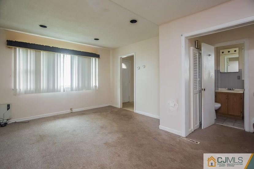 385 Florida Grove Road Perth Amboy, NJ 08861 - Photo 7 of 13 a view of an empty room with a window