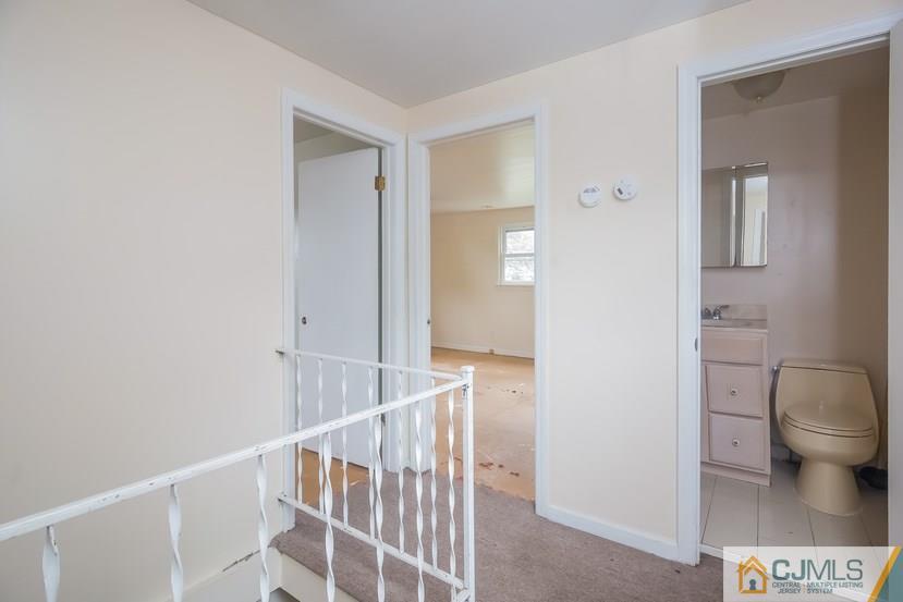 385 Florida Grove Road Perth Amboy, NJ 08861 - Photo 10 of 13 a view of a hallway with wooden floor and a bathroom