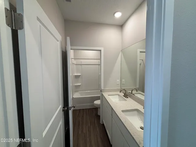 an empty room with closet and a window