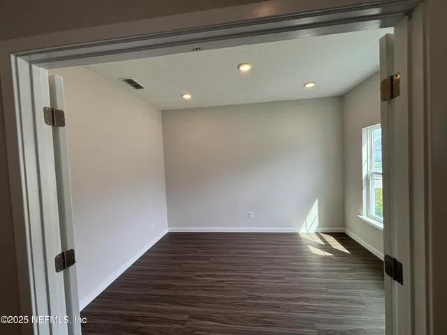 a kitchen with refrigerator and cabinets