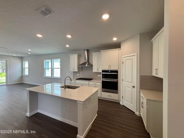a bathroom with a double vanity sink and mirror