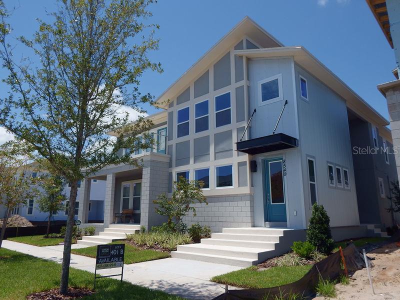 a front view of a house with yard and green space