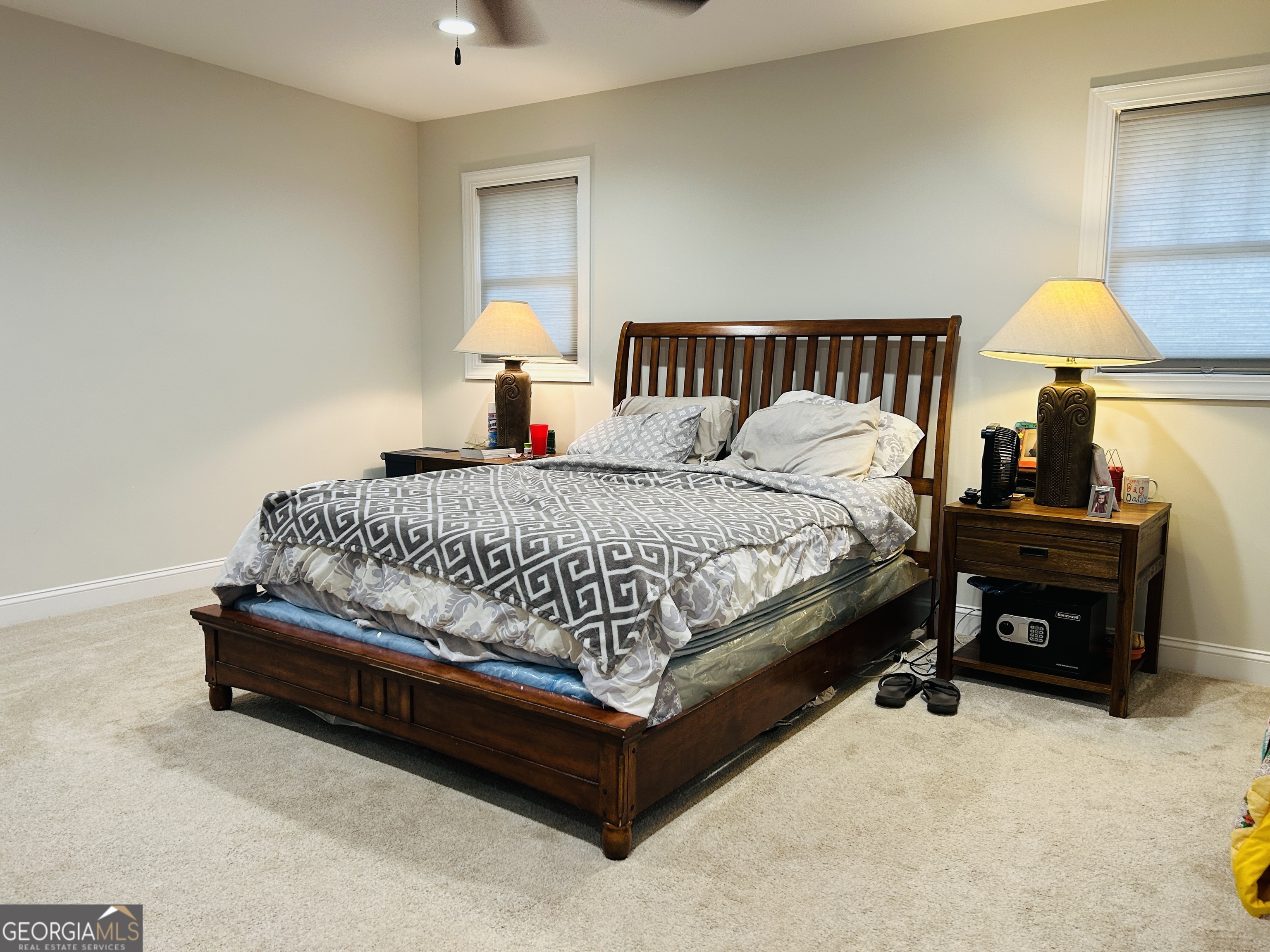 3077 Alec Mountain Road Clarkesville, GA 30523 - Photo 22 of 35 a bed sitting in a bedroom next to a lamp
