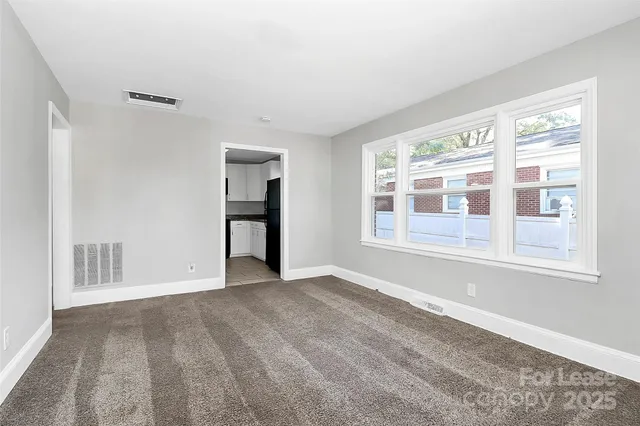 a view of an empty room with a window