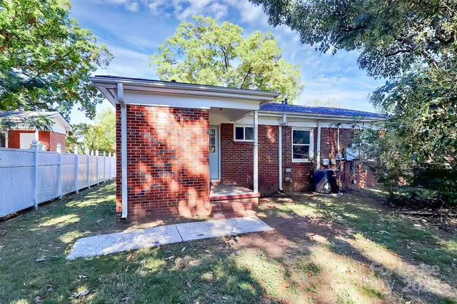 a view of a chairs and table in the backyard of the house