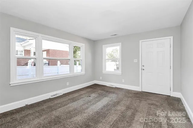 a view of an empty room with a window